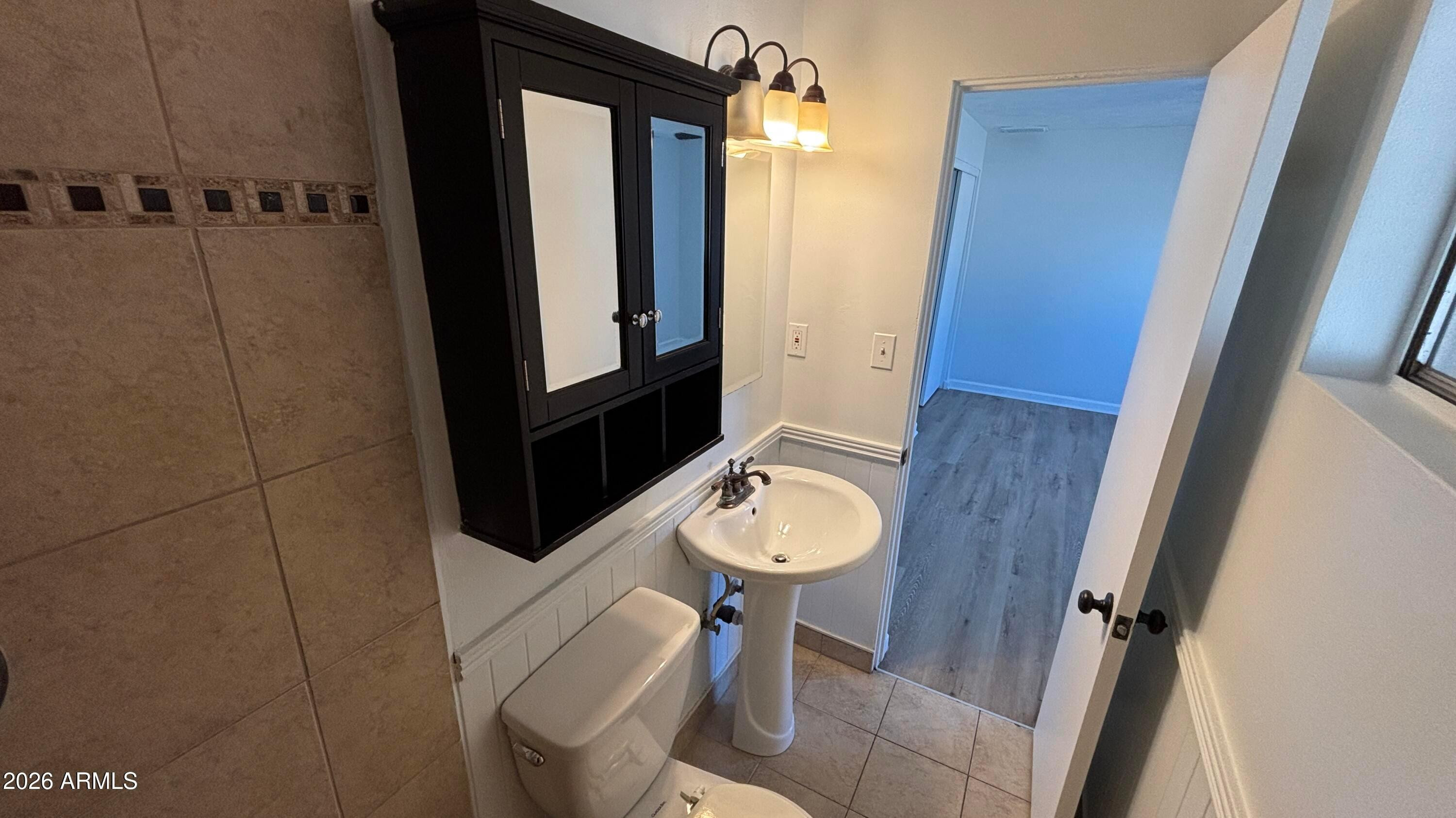 1000 West Elna Rae Street Tempe, AZ 85281 - Photo 20 of 22 a bathroom with a sink a toilet a mirror and shower