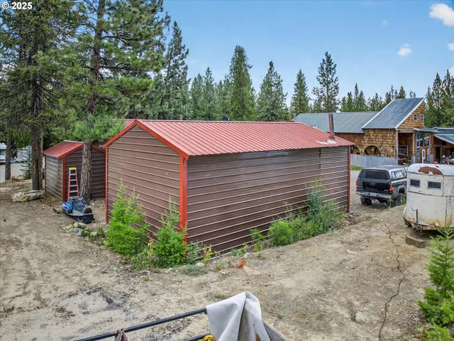 an aerial view of a house with table and chairs