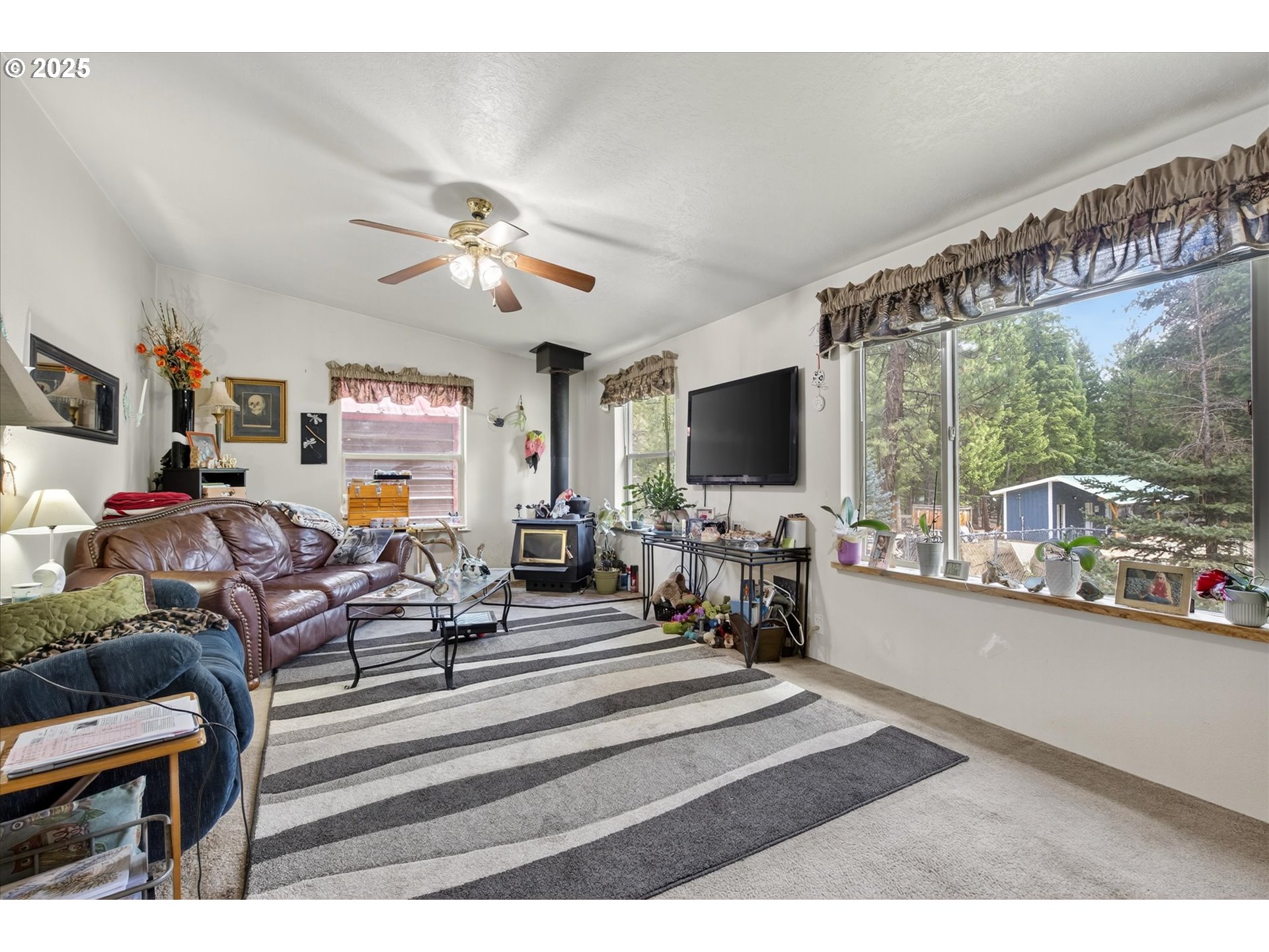 600 Northwest Cupid Avenue Sumpter, OR 97877 - Photo 2 of 29 a living room with furniture and a flat screen tv
