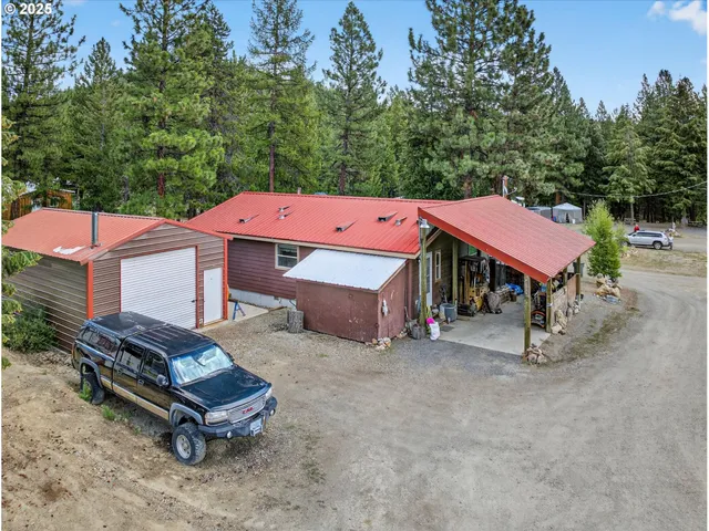 an aerial view of residential house with outdoor space and parking
