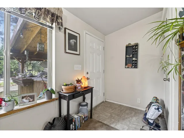 a living room with furniture and a floor to ceiling window