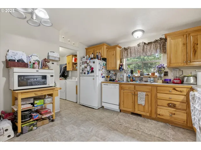 a kitchen with cabinets a sink and appliances