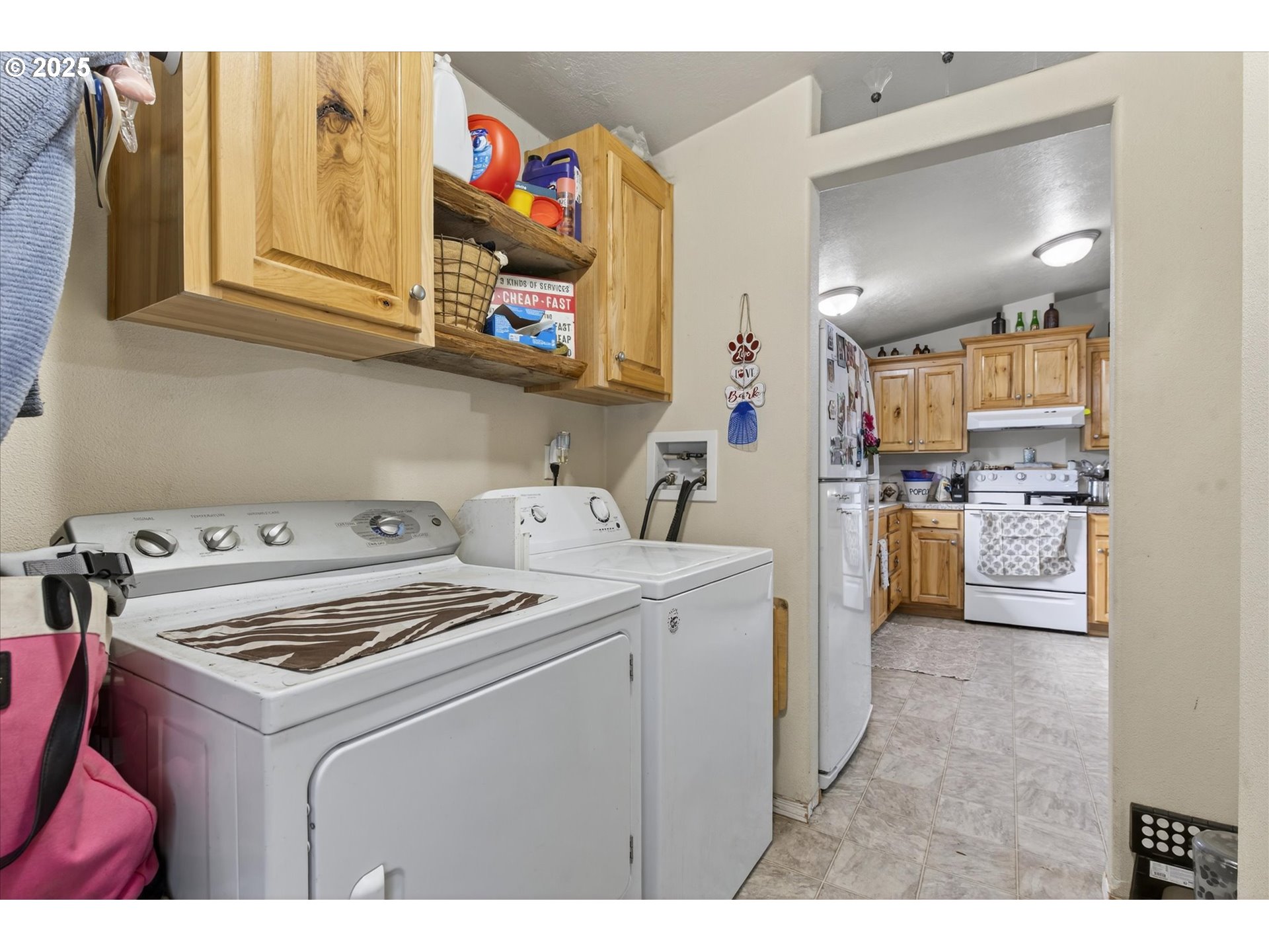 600 Northwest Cupid Avenue Sumpter, OR 97877 - Photo 10 of 29 a utility room with cabinets dryer and washer