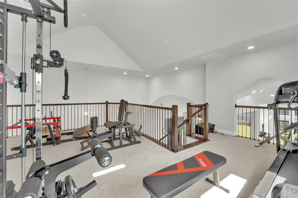 3520 Helios Lane Corinth, TX 76208 - Photo 34 of 37 Spacious loft area featuring vaulted ceilings, recessed lighting, and soft carpet flooring