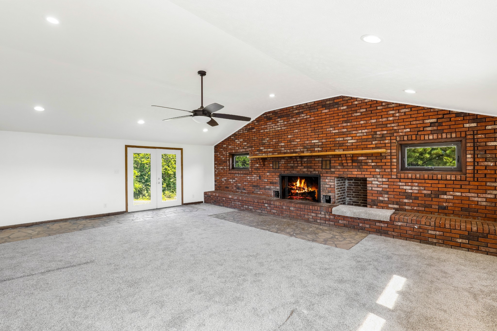 239 Wayne Threatt Road Dover, TN 37058 - Photo 20 of 41 an empty room with fireplace and windows