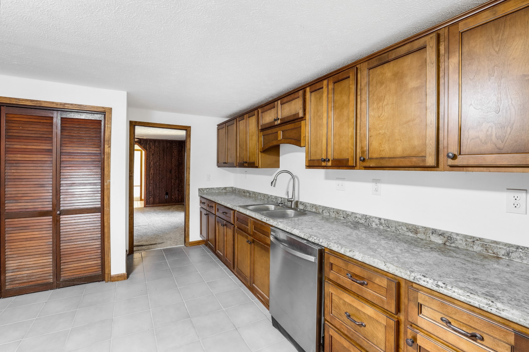 239 Wayne Threatt Road Dover, TN 37058 - Photo 25 of 41 a kitchen with stainless steel appliances granite countertop a sink and a refrigerator with wooden cabinets