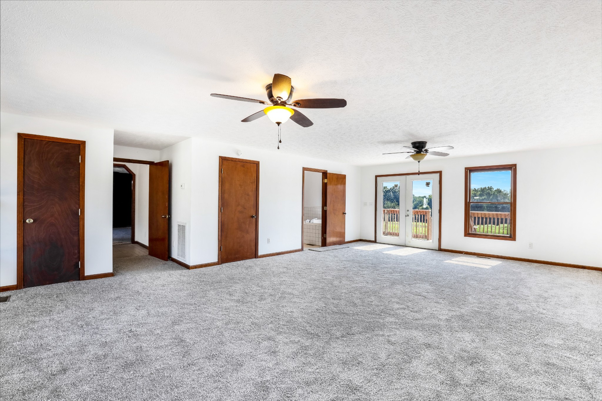 239 Wayne Threatt Road Dover, TN 37058 - Photo 29 of 41 an empty room with chandelier fan and windows