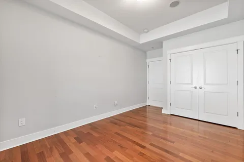 a view of an empty room with wooden floor