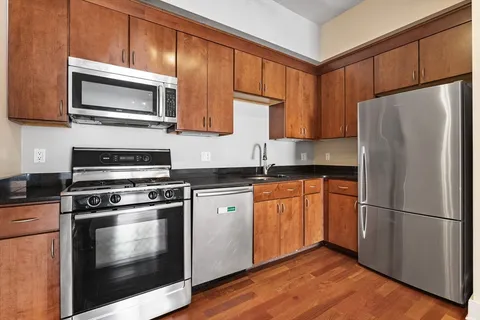 a kitchen with stainless steel appliances a stove a microwave and a refrigerator