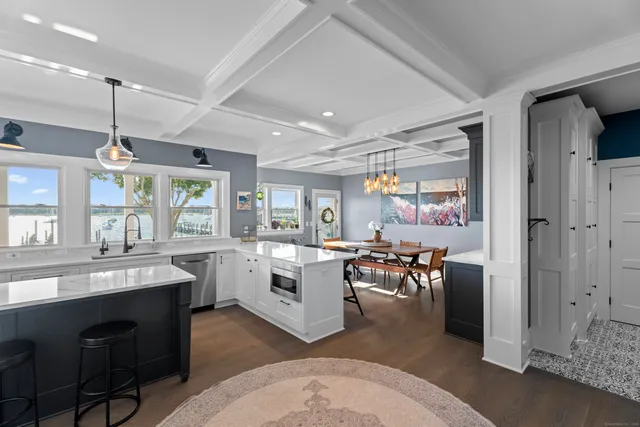 a kitchen with a sink and chairs