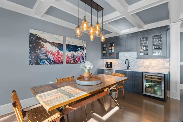a view of a dining room with furniture and chandelier