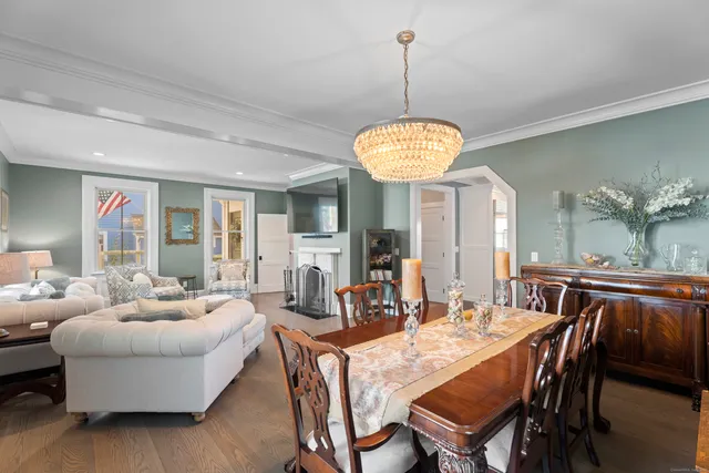 a view of a dining room with furniture wooden floor and chandelier