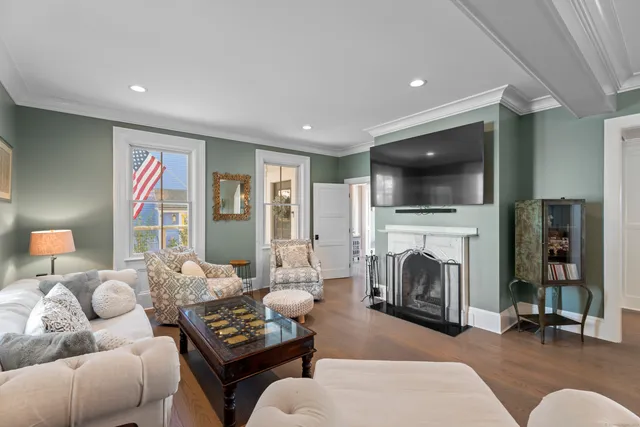 a living room with furniture flat screen tv and a fireplace