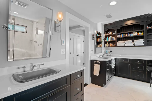 a bathroom with a glass shower door