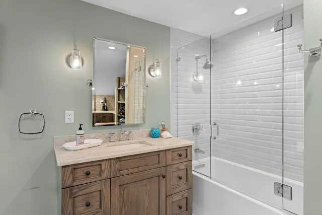 a kitchen with stainless steel appliances granite countertop a refrigerator a sink and a stove