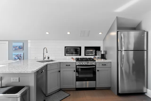 a kitchen with granite countertop a sink and a stove top oven