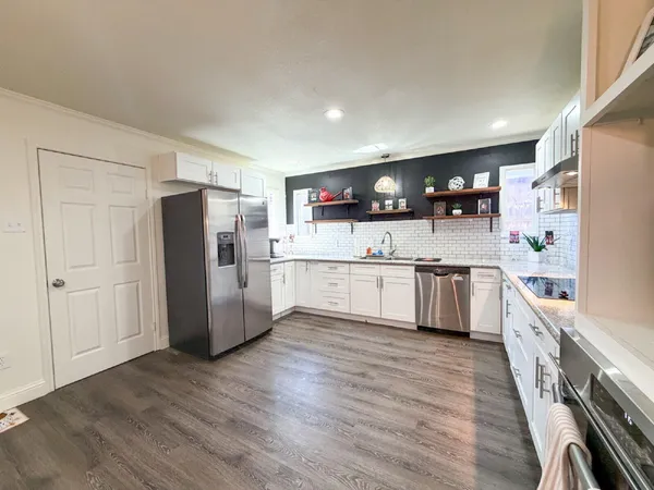 a kitchen with stainless steel appliances granite countertop wooden cabinets and a granite counter tops