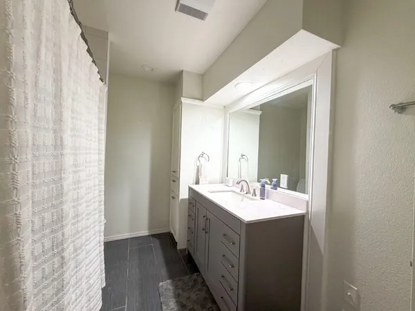 an empty room with a window and a fan
