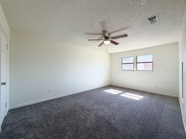 a spacious bedroom with two beds and a couch