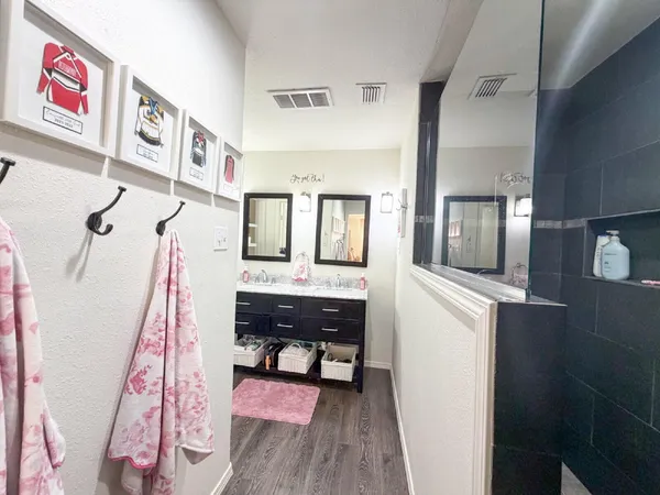 a view of a hallway and a livingroom with furniture