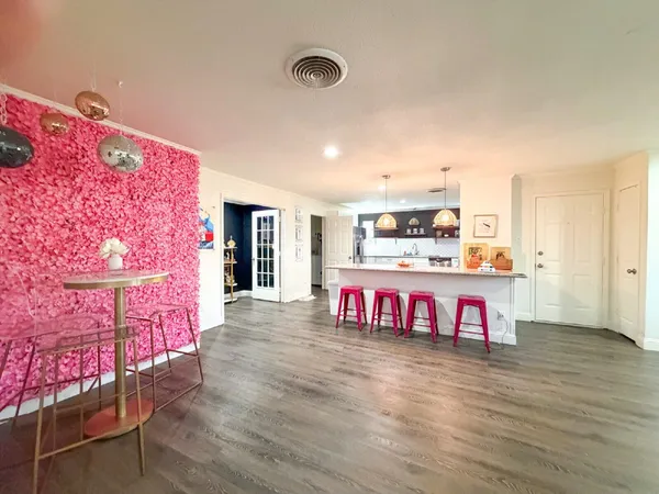 a large kitchen with a table and chairs
