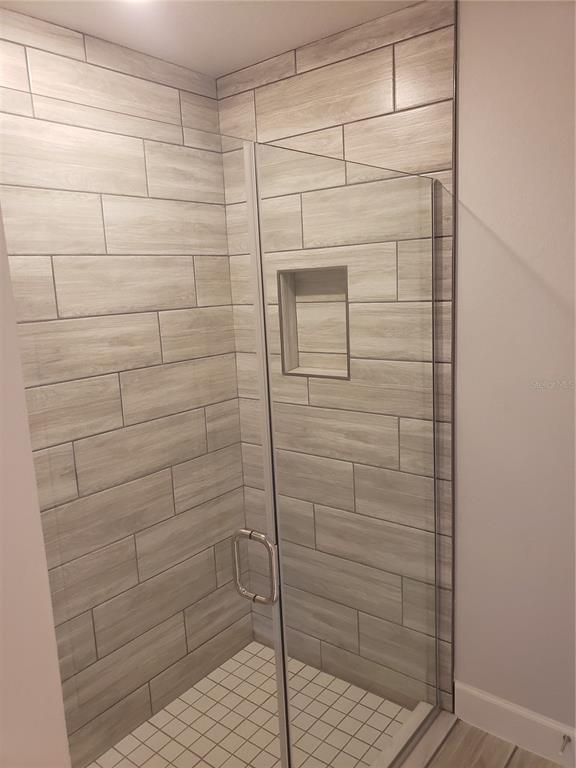 4858 Sutherland St Spring Hill, Unit LOT 61 Spring Hill, FL 34609 - Photo 13 of 15 a bathroom with a shower
