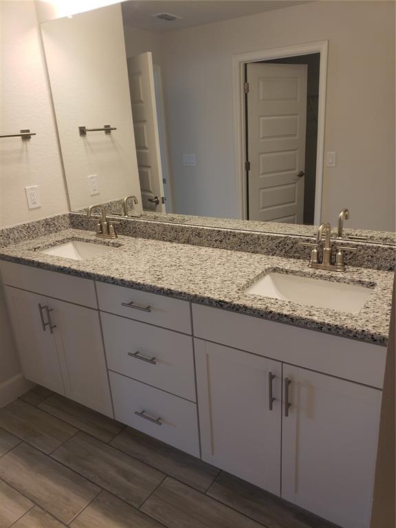 4858 Sutherland St Spring Hill, Unit LOT 61 Spring Hill, FL 34609 - Photo 14 of 15 a bathroom with a granite countertop sink and a mirror
