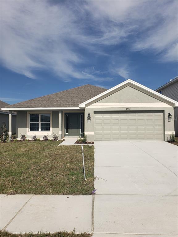 4858 Sutherland St Spring Hill, Unit LOT 61 Spring Hill, FL 34609 - Photo 2 of 15 front view of house with a yard