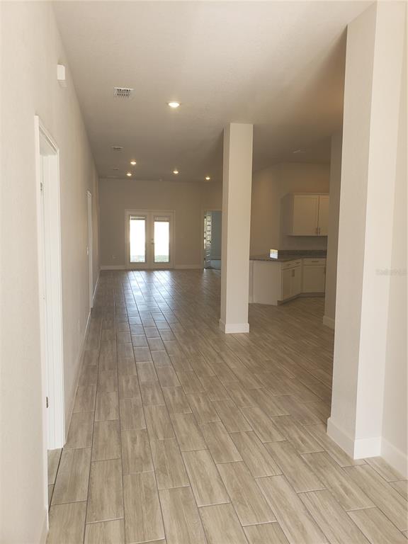 4858 Sutherland St Spring Hill, Unit LOT 61 Spring Hill, FL 34609 - Photo 5 of 15 a view of a room with wooden floor