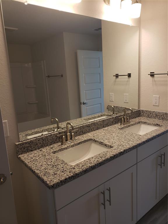 4858 Sutherland St Spring Hill, Unit LOT 61 Spring Hill, FL 34609 - Photo 8 of 15 a bathroom with a granite countertop sink and a mirror