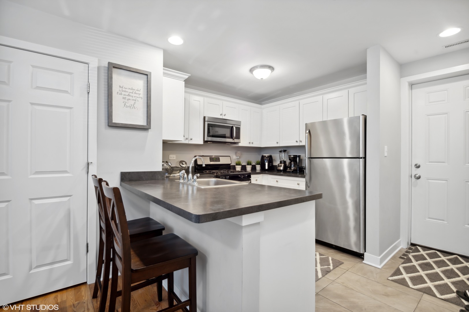 2458 North Lotus Avenue Chicago, IL 60639 - Photo 14 of 22 a kitchen with stainless steel appliances granite countertop a refrigerator a stove a sink a dining table and chairs