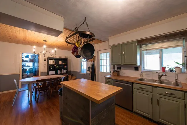 a kitchen with a table chairs and wooden floor