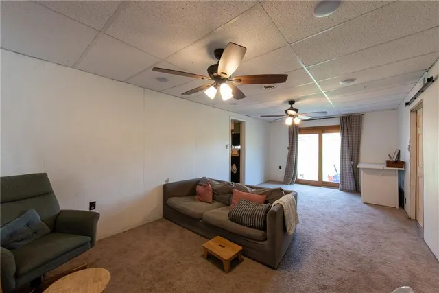 a living room with furniture and a ceiling fan