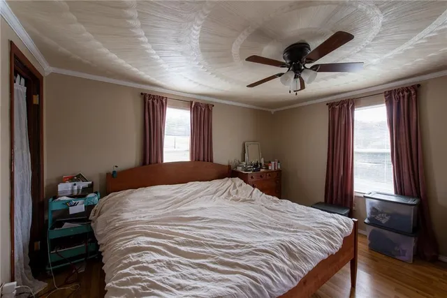 a bedroom with a large bed and a window
