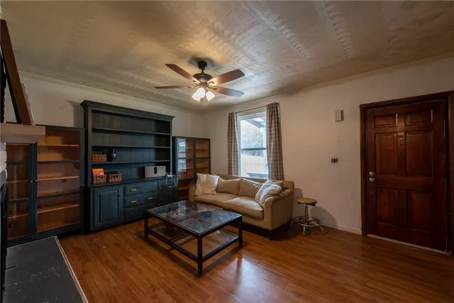 a living room with furniture and wooden floor