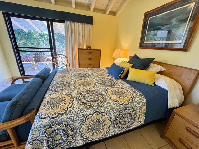 a bedroom with furniture and a large window