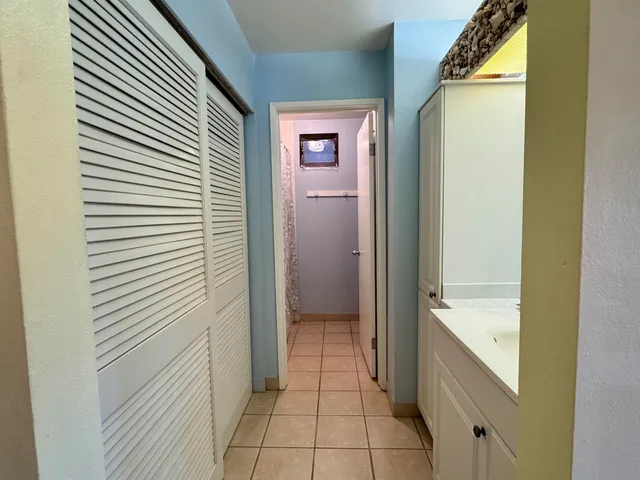 a en suite bathroom with a sink a mirror and a shower
