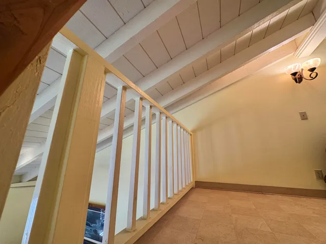 a view of a house with a yard and potted plants