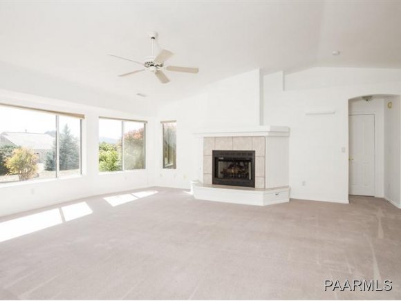 5732 Columbine Road Prescott, AZ 86305 - Photo 5 of 24 a view of an empty room with a fireplace and a window