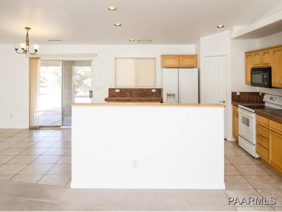 5732 Columbine Road Prescott, AZ 86305 - Photo 8 of 24 a kitchen with a sink and a stove top oven with wooden floor