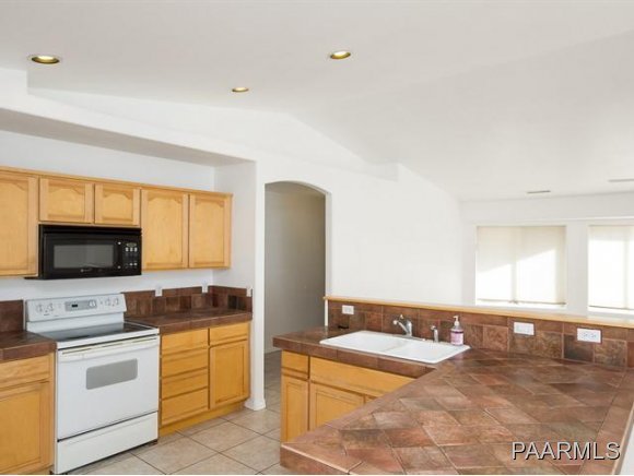 5732 Columbine Road Prescott, AZ 86305 - Photo 9 of 24 a kitchen with stainless steel appliances granite countertop a stove and a sink