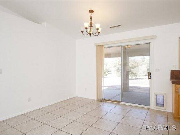 5732 Columbine Road Prescott, AZ 86305 - Photo 10 of 24 an empty room with windows and chandelier
