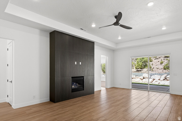 2862 South Mountain Rnch Road Cedar City, UT 84720 - Photo 5 of 64 Spacious living area featuring a dark wood-finish media wall with an integrated fireplace