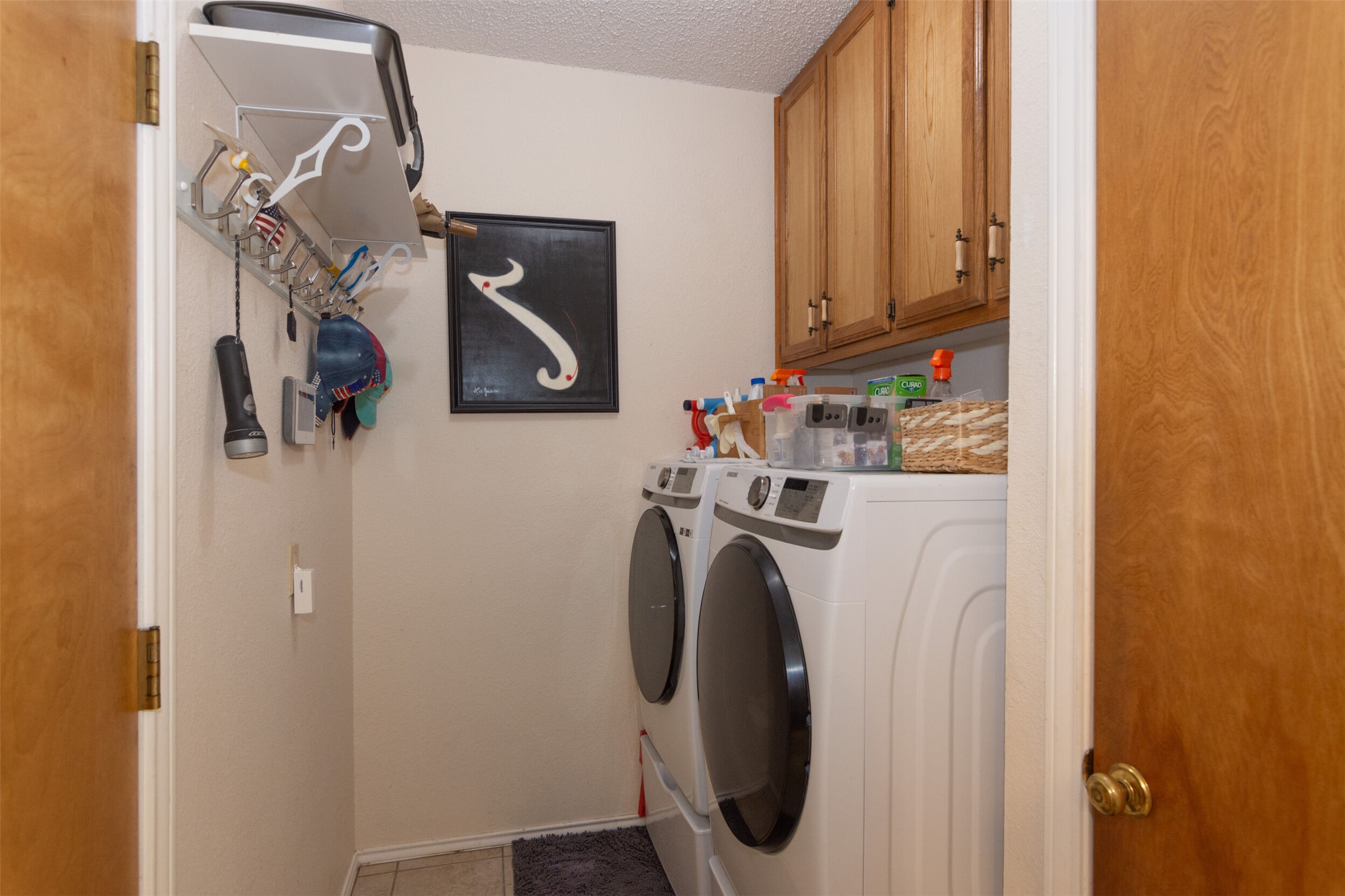 219 Turtle Bend Georgetown, TX 78628 - Photo 18 of 37 Ample wooden cabinetry and built-in shelving maximize storage space in this functional laundry room.