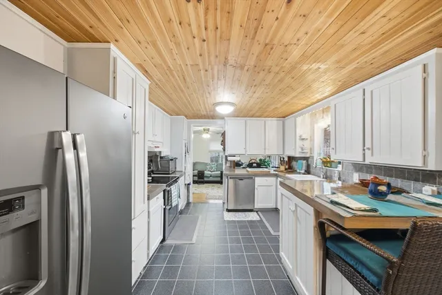 a kitchen with stainless steel appliances a refrigerator sink and cabinets