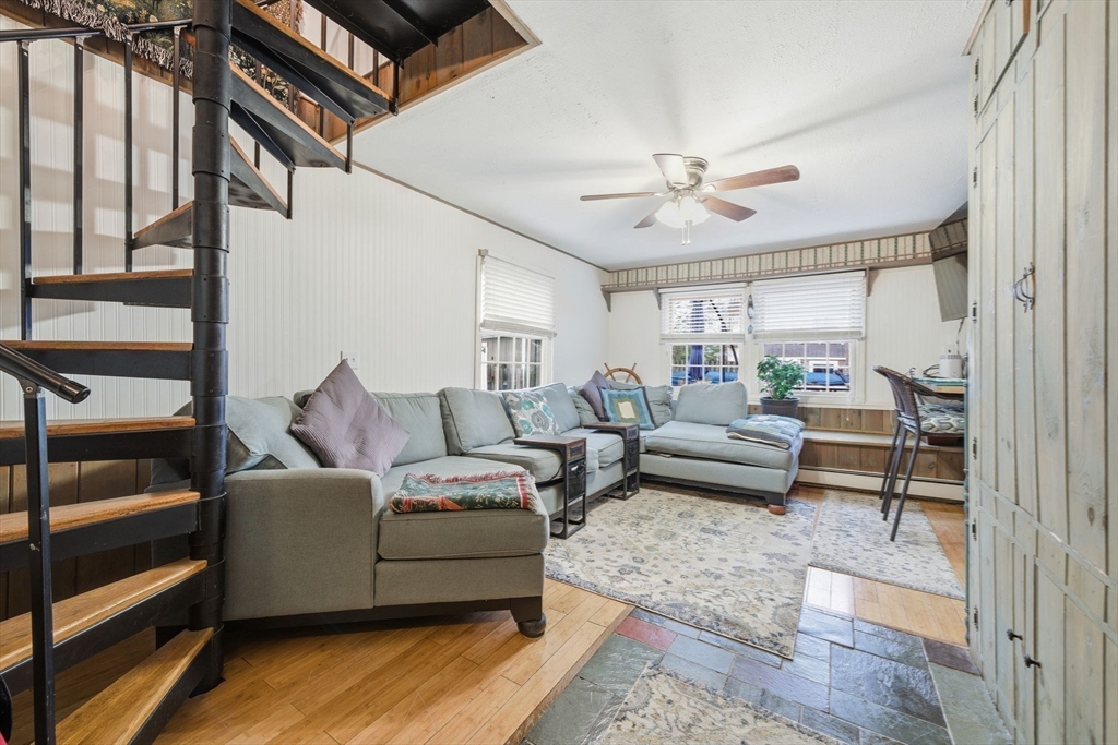 4 Laurel Street Woburn, MA 01801 - Photo 18 of 40 a living room with furniture and a chandelier
