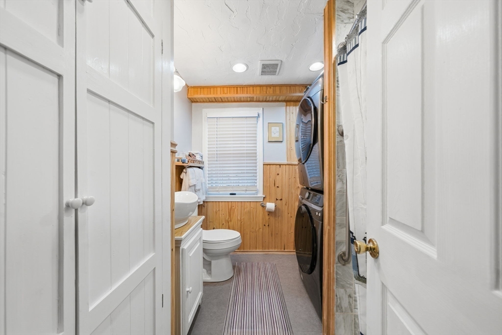 4 Laurel Street Woburn, MA 01801 - Photo 20 of 40 a bathroom with a granite countertop toilet a sink and a shower