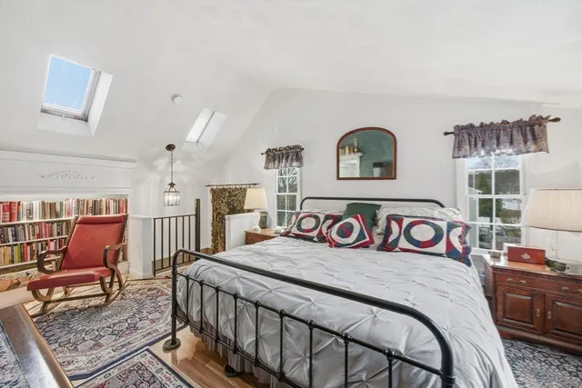 a bedroom with a bed a couch and dresser