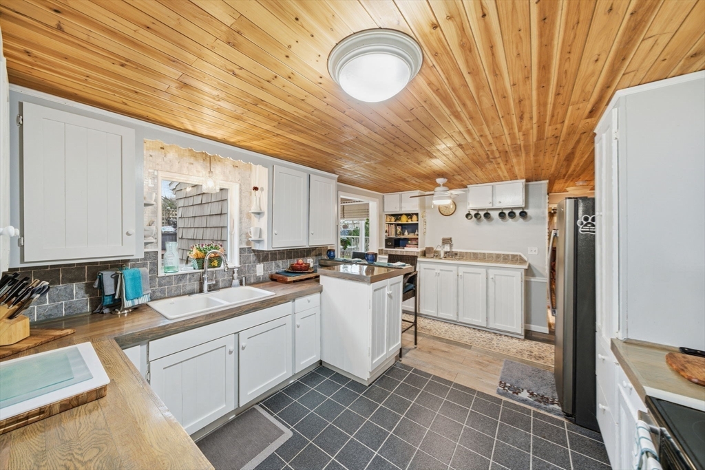 4 Laurel Street Woburn, MA 01801 - Photo 9 of 40 a kitchen with white cabinets and white appliances