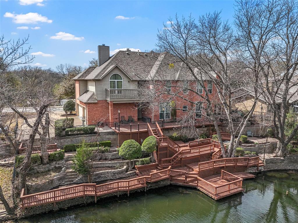 705 Findlay Drive Arlington, TX 76012 - Photo 1 of 1 a front view of a house with a garden and lake view